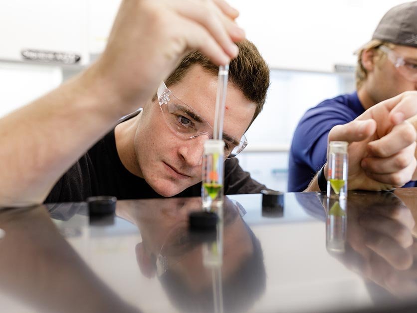 A student measures liquid in a beaker